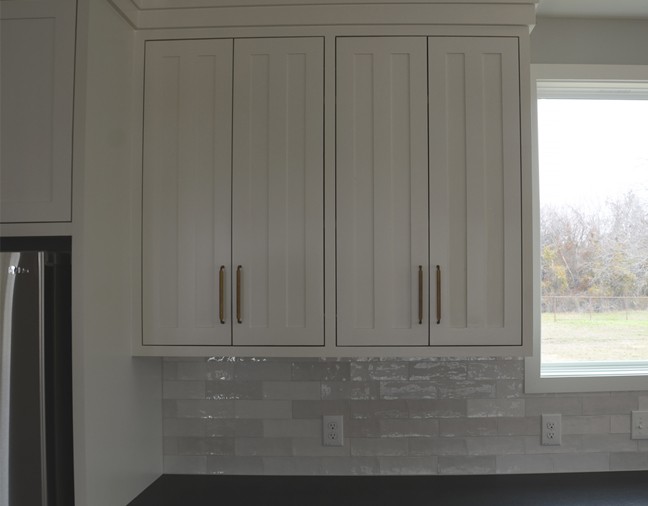 white custom wooden kitchen cabinet mounted on the wall by renovacraft