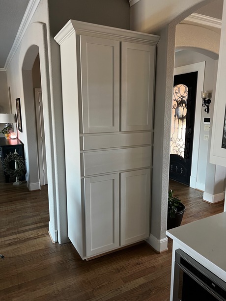 A stylish custom white kitchen cabinet featuring four doors, offering both elegance and practicality.